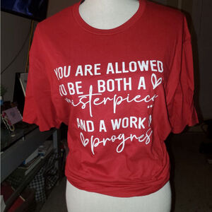 You can be both a masterpiece & a work in progress! With this inspiring red Tee